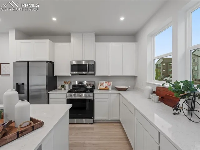a kitchen with a sink stove and refrigerator