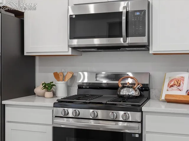 a stove top oven sitting inside of a kitchen