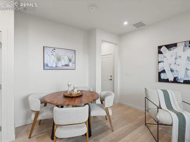 a dining room with furniture and wooden floor