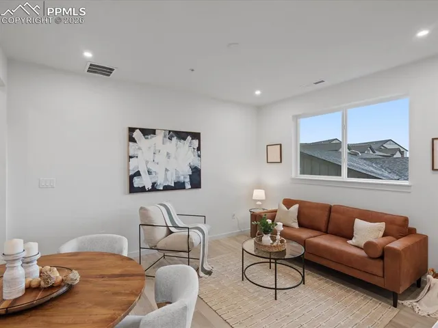 a living room with furniture and wall paintings