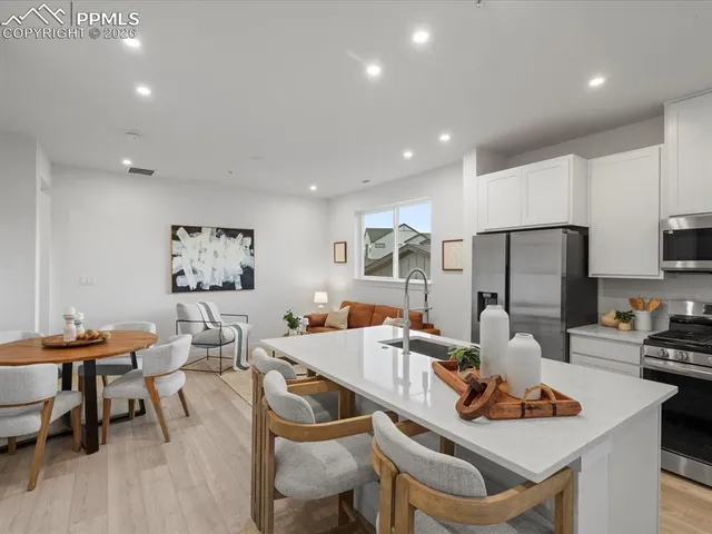 a dining room with furniture and wooden floor