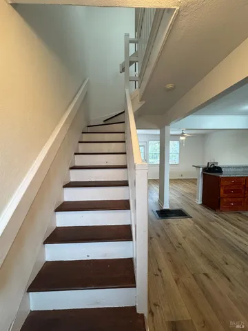 a view of entryway and hall with wooden floor