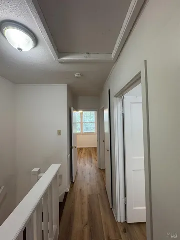 a view of hallway with wooden floor