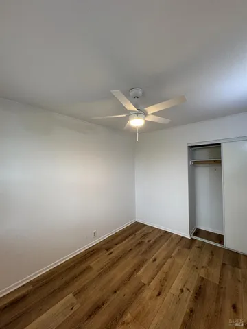 an empty room with a fan & a fan