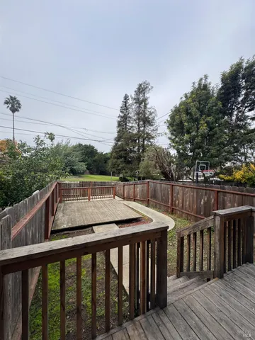 a view of deck with patio and wooden floor