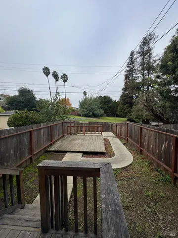 a view of a roof deck with furniture
