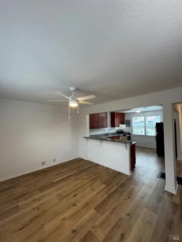 a view of a living room and kitchen with a flat screen tv