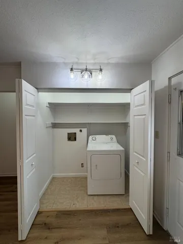 a utility room with cabinets washer and dryer