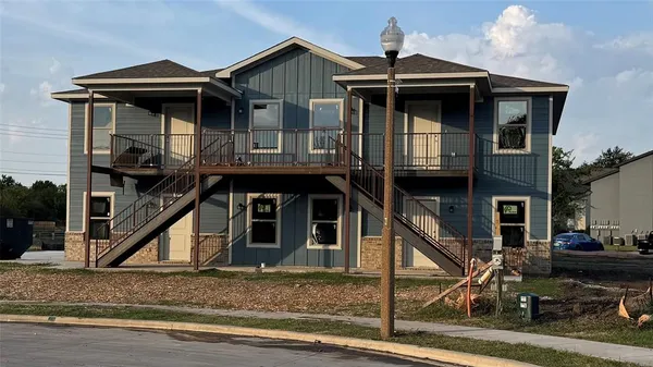 a view of a house with wooden deck