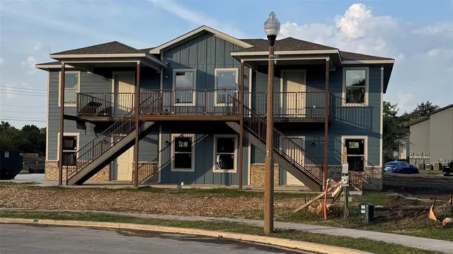 a view of a house with wooden deck