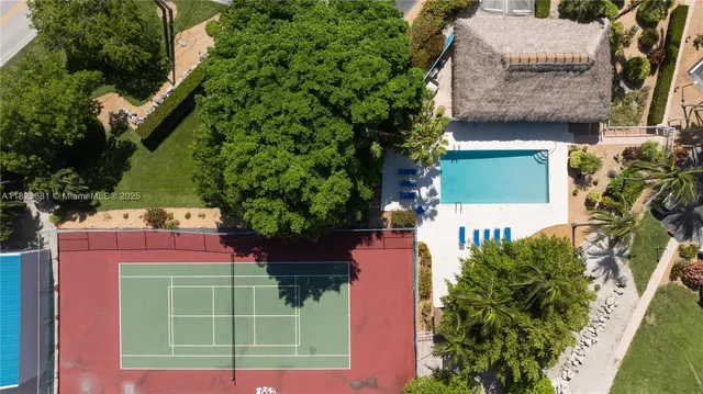 an aerial view of a house with swimming pool and outdoor seating
