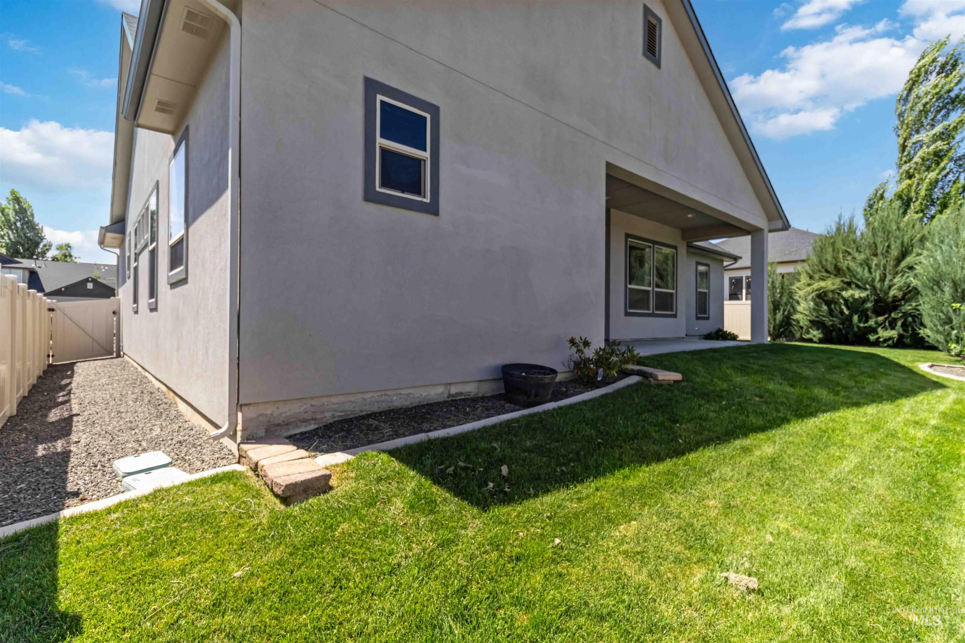 3218 North Cherry Laurel Way Star, ID 83669 - Photo 48 of 50 Expansive backyard featuring a manicured lawn, perimeter fencing, and established shrubs