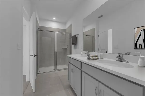 a bathroom with a double vanity sink mirror and double