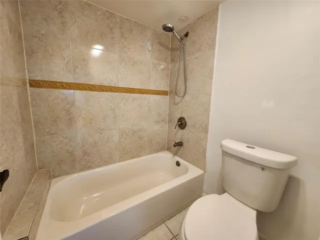 a white bath tub sitting next to a toilet