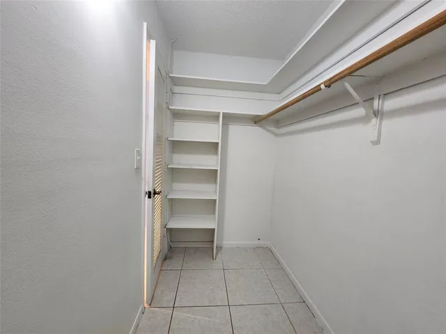 a view of an empty walk in closet