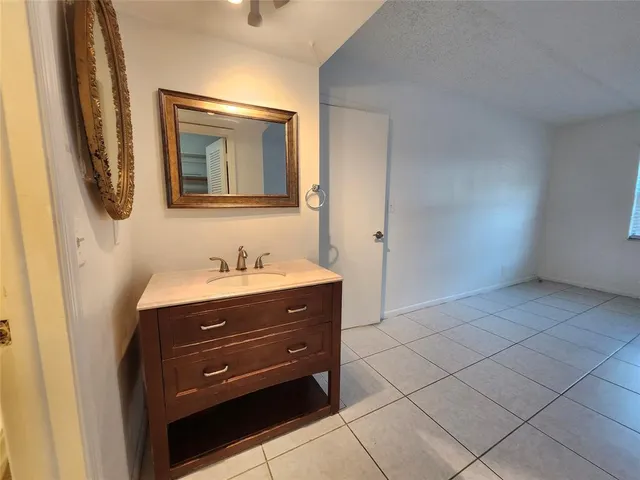 a bathroom with a sink vanity and mirror