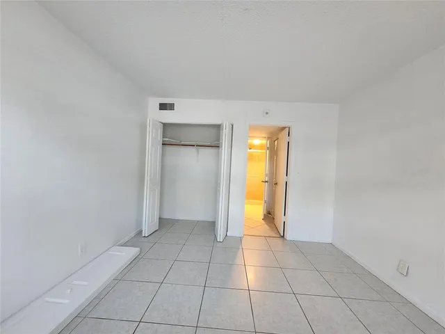 a view of an empty room with a bathroom