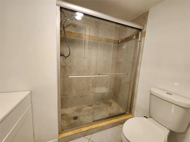 a bathroom with a shower and toilet