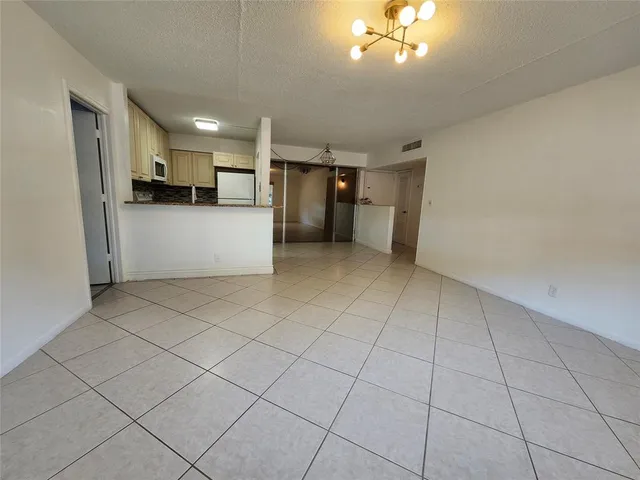 a view of a kitchen with a sink and cabinets