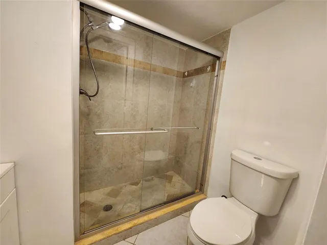 a bathroom with a shower and toilet