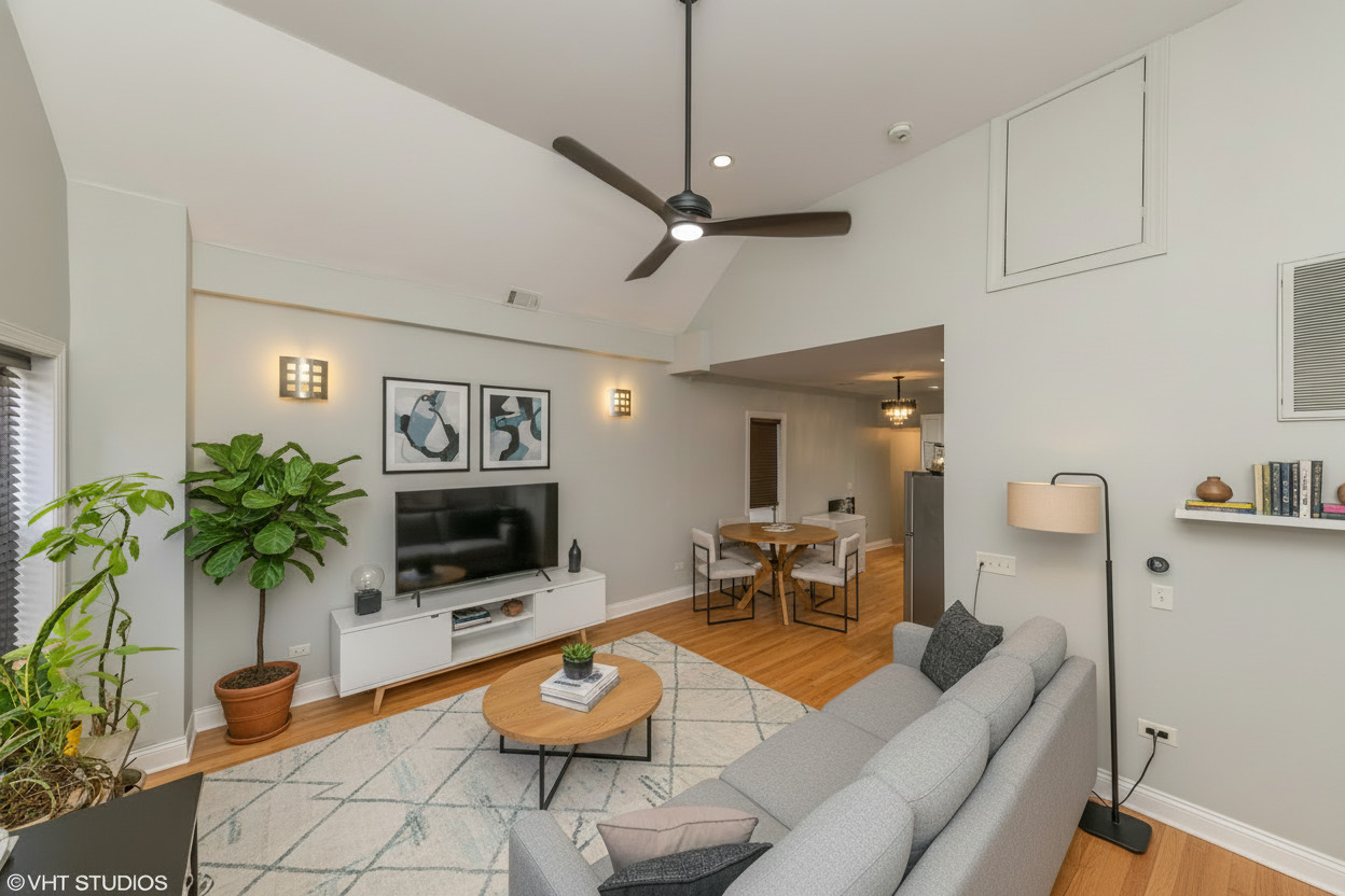 2009 West 17th Street, Unit 1F Chicago, IL 60608 - Photo 2 of 9 a living room with furniture a flat screen tv and a potted plant