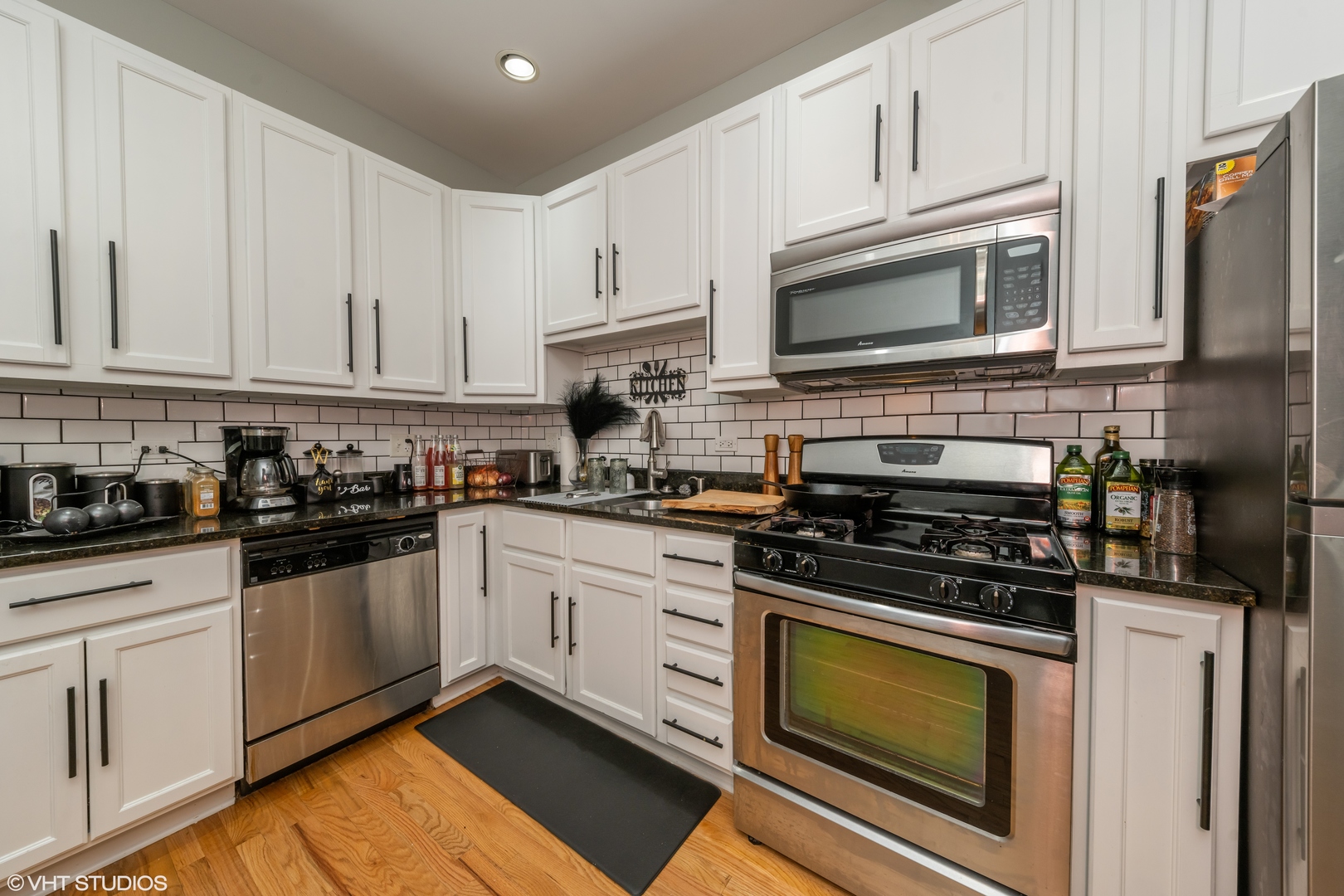 2009 West 17th Street, Unit 1F Chicago, IL 60608 - Photo 4 of 9 a kitchen with stainless steel appliances granite countertop grey cabinets a stove a sink and dishwasher