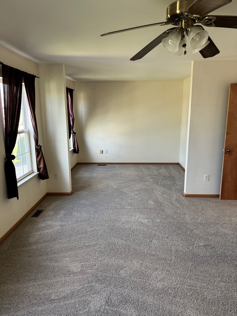 674 Shannon Drive, Unit 674 Romeoville, IL 60446 - Photo 13 of 13 a view of a room with a ceiling fan