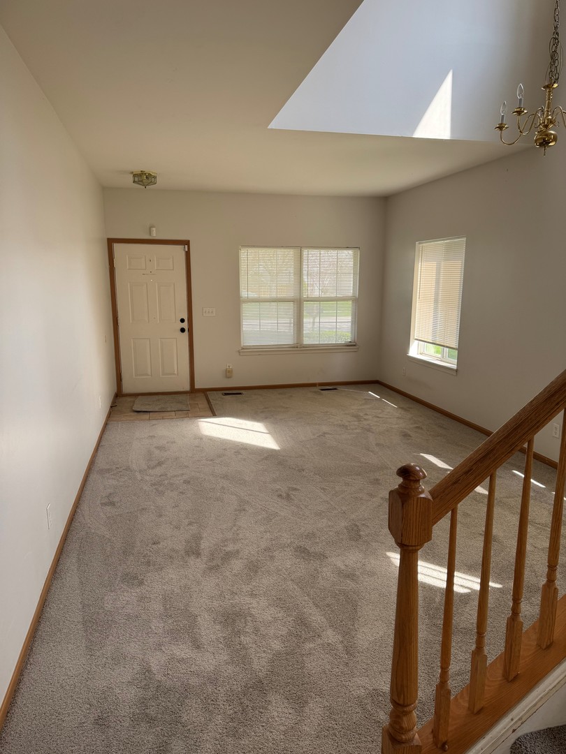 674 Shannon Drive, Unit 674 Romeoville, IL 60446 - Photo 2 of 13 an empty room with windows