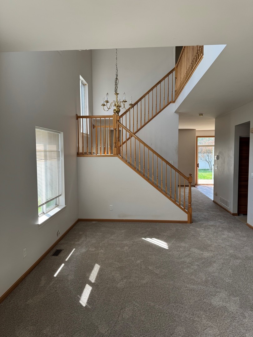 674 Shannon Drive, Unit 674 Romeoville, IL 60446 - Photo 3 of 13 a view of an empty room with stairs