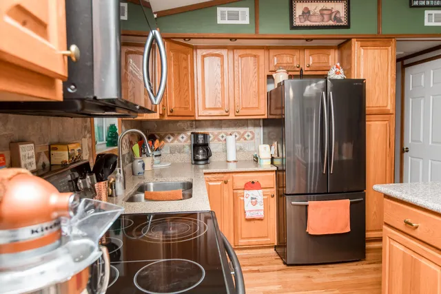 a kitchen with stainless steel appliances granite countertop a refrigerator and a stove
