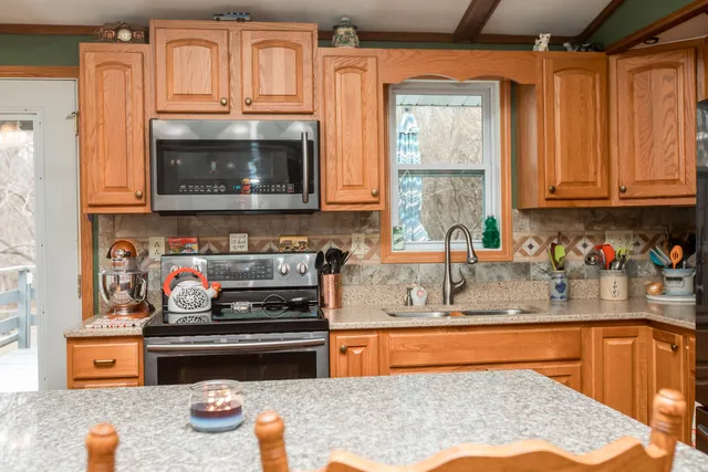 a kitchen with stainless steel appliances granite countertop a stove and a sink