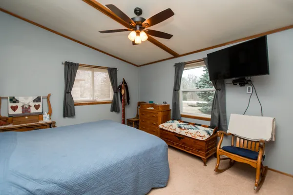 a bedroom with furniture and a window