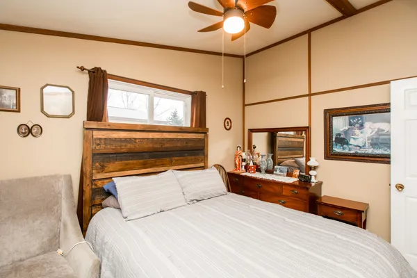 a bedroom with a bed and a chandelier