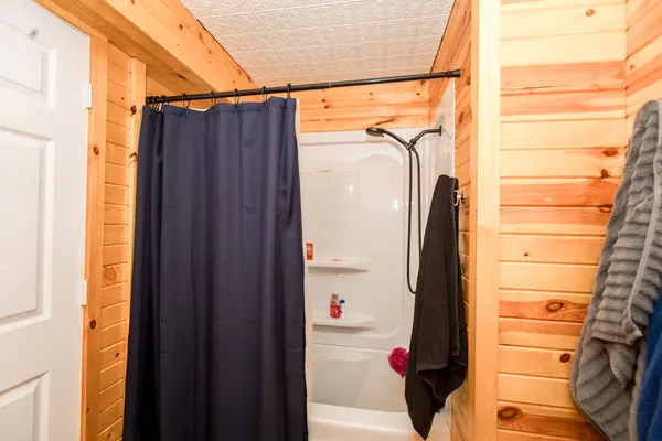 a view of walk in closet with clothes