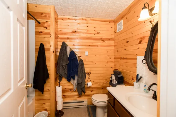 a bathroom with a toilet sink and mirror