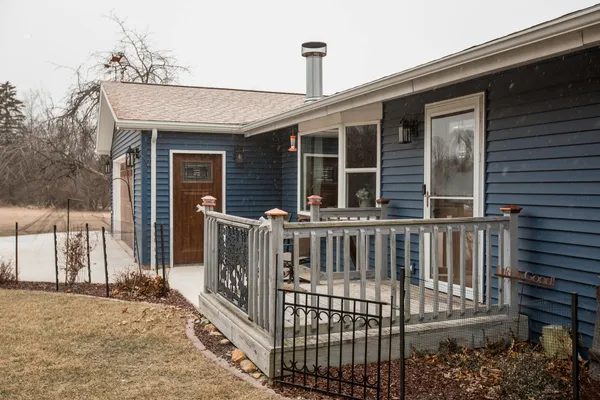 a view of a house with a wooden deck