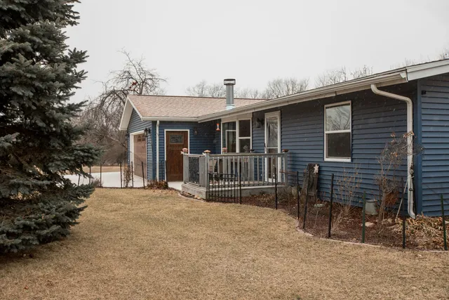 a view of a house with a backyard and deck