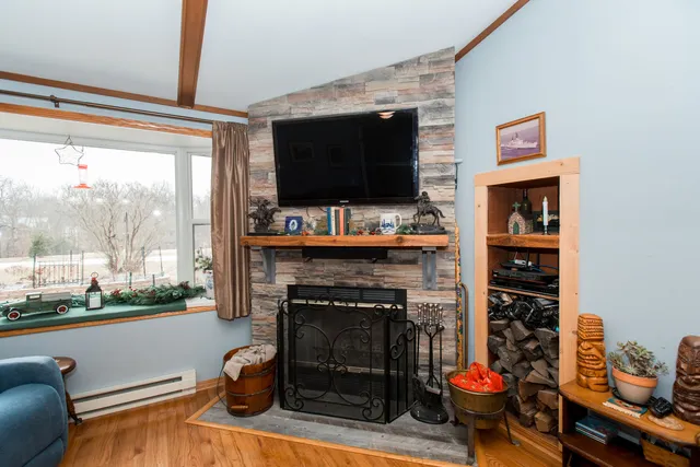 a living room with fireplace and a flat screen tv