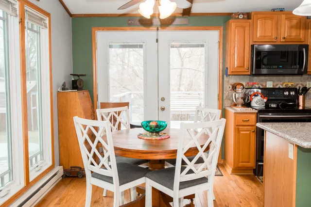 a dining room with furniture a window and a flat screen tv