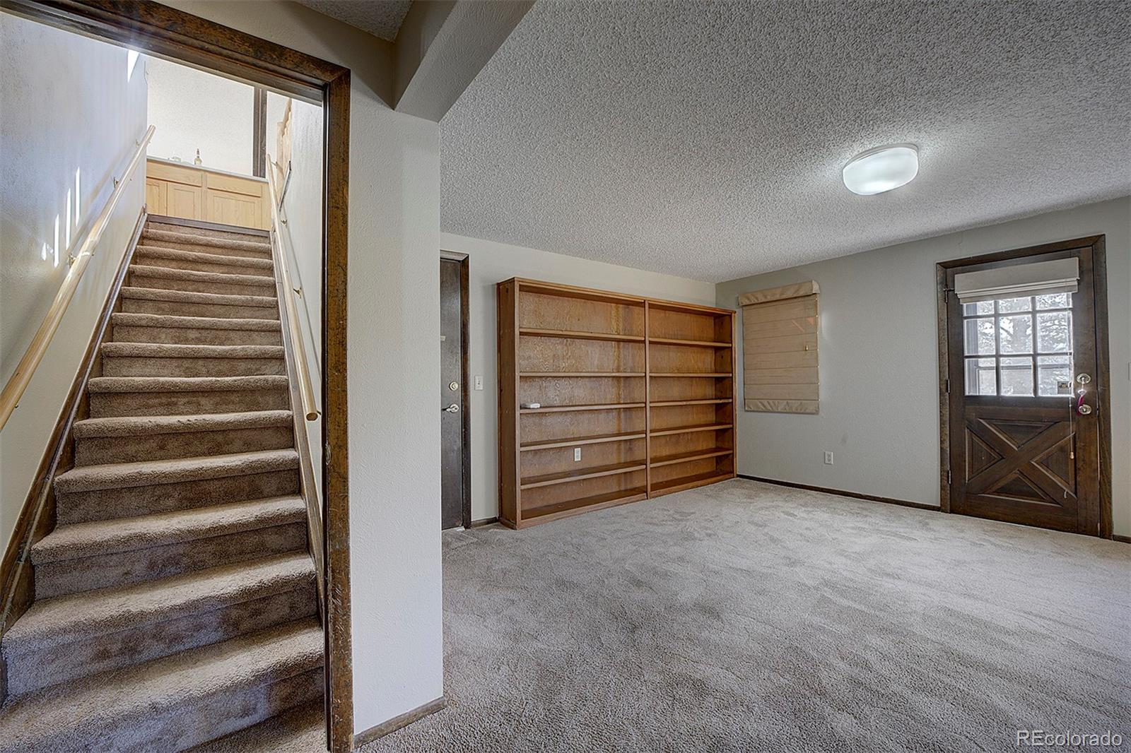 6561 Ridgeview Drive Morrison, CO 80465 - Photo 22 of 36 a view of an empty room with a fireplace
