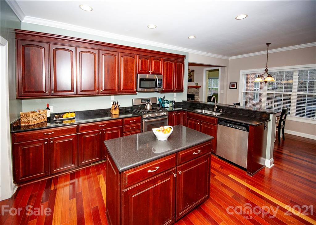 3334 Millstone Creek Road Lancaster, SC 29720 - Photo 6 of 17 a kitchen with stainless steel appliances granite countertop a sink stove and cabinets