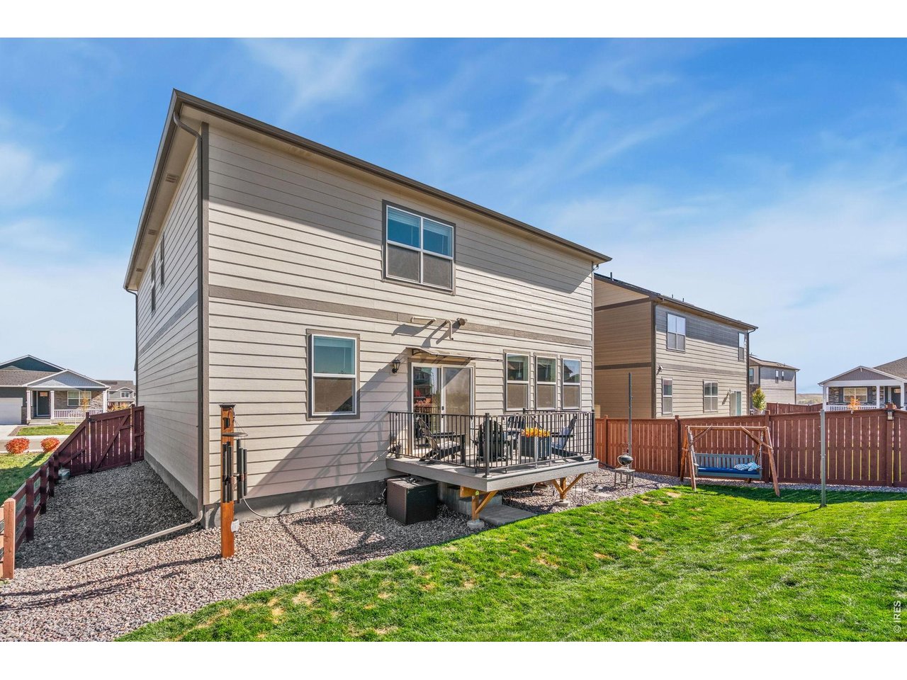 438 Bluebird Road Johnstown, CO 80534 - Photo 31 of 33 Backyard Deck (outdoor swing included)