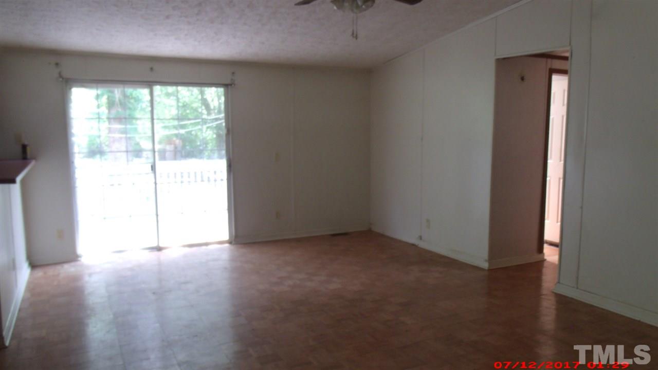 1129 Taos Trail Raleigh, NC 27603 - Photo 3 of 10 an empty room with wooden floor and windows