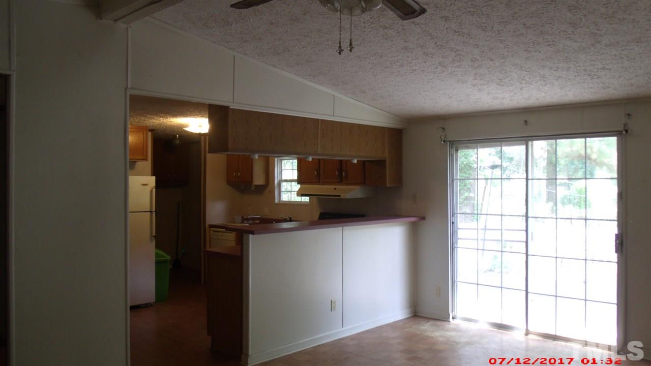 1129 Taos Trail Raleigh, NC 27603 - Photo 4 of 10 a kitchen with a sink a microwave and cabinets