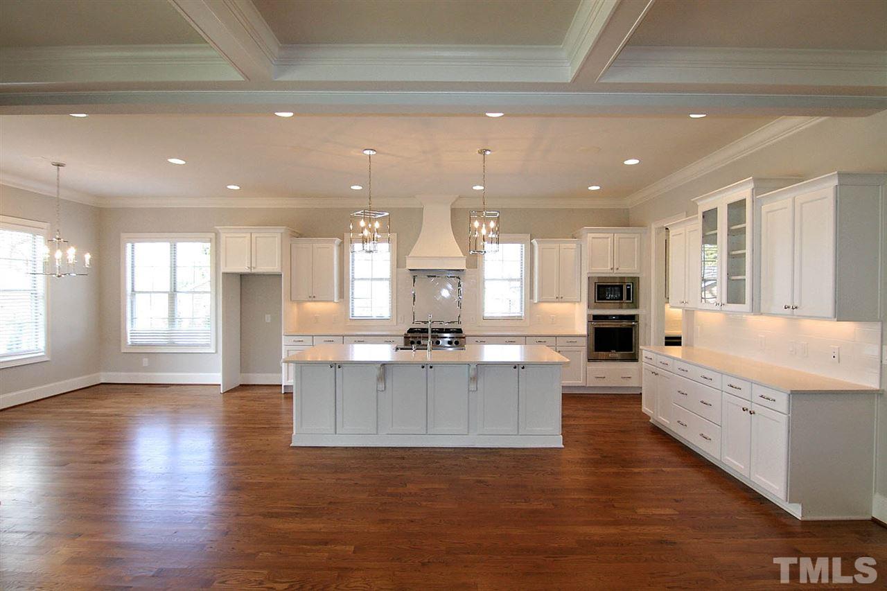 4011 Edwards Mill Road Raleigh, NC 27612 - Photo 2 of 25 a large kitchen with granite countertop a large counter top stainless steel appliances and cabinets