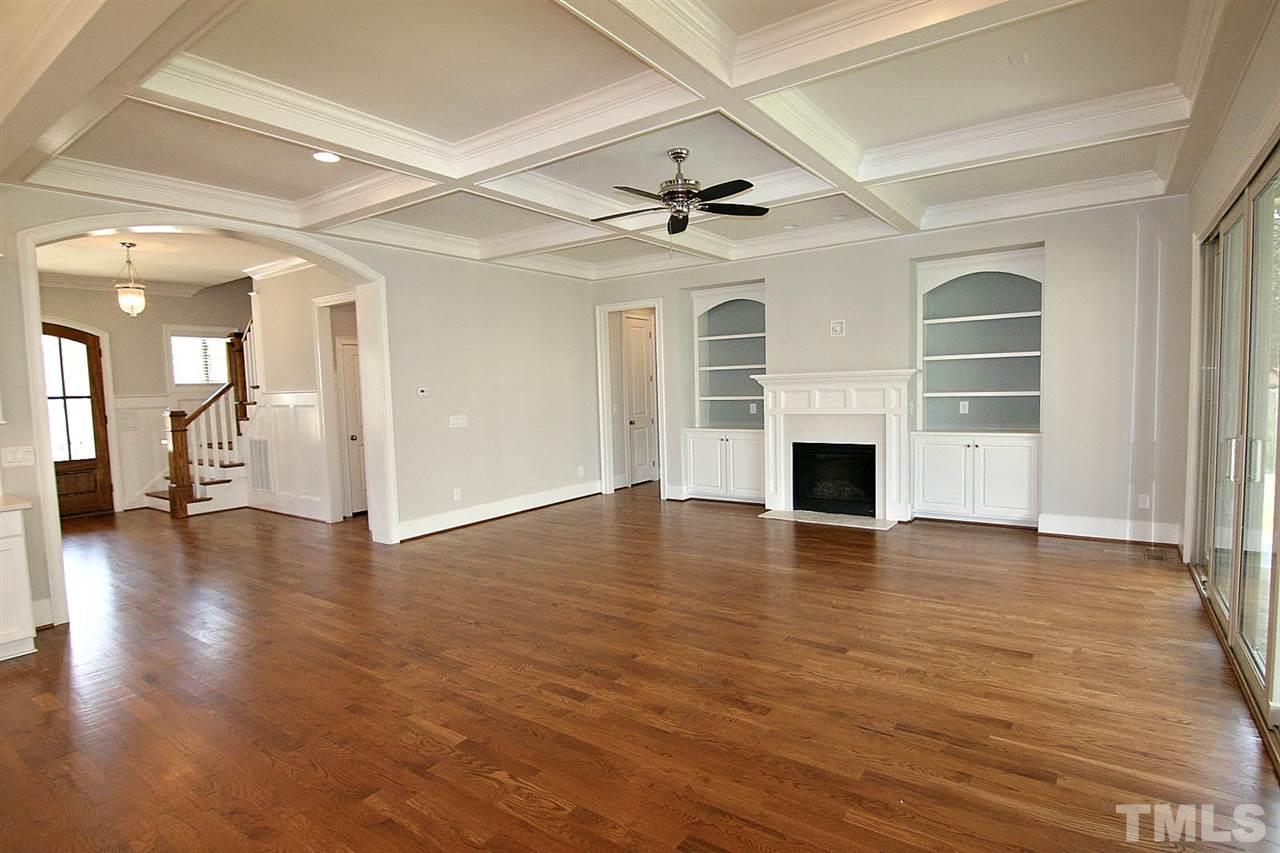 4011 Edwards Mill Road Raleigh, NC 27612 - Photo 15 of 25 a view of a livingroom with wooden floor and a ceiling fan