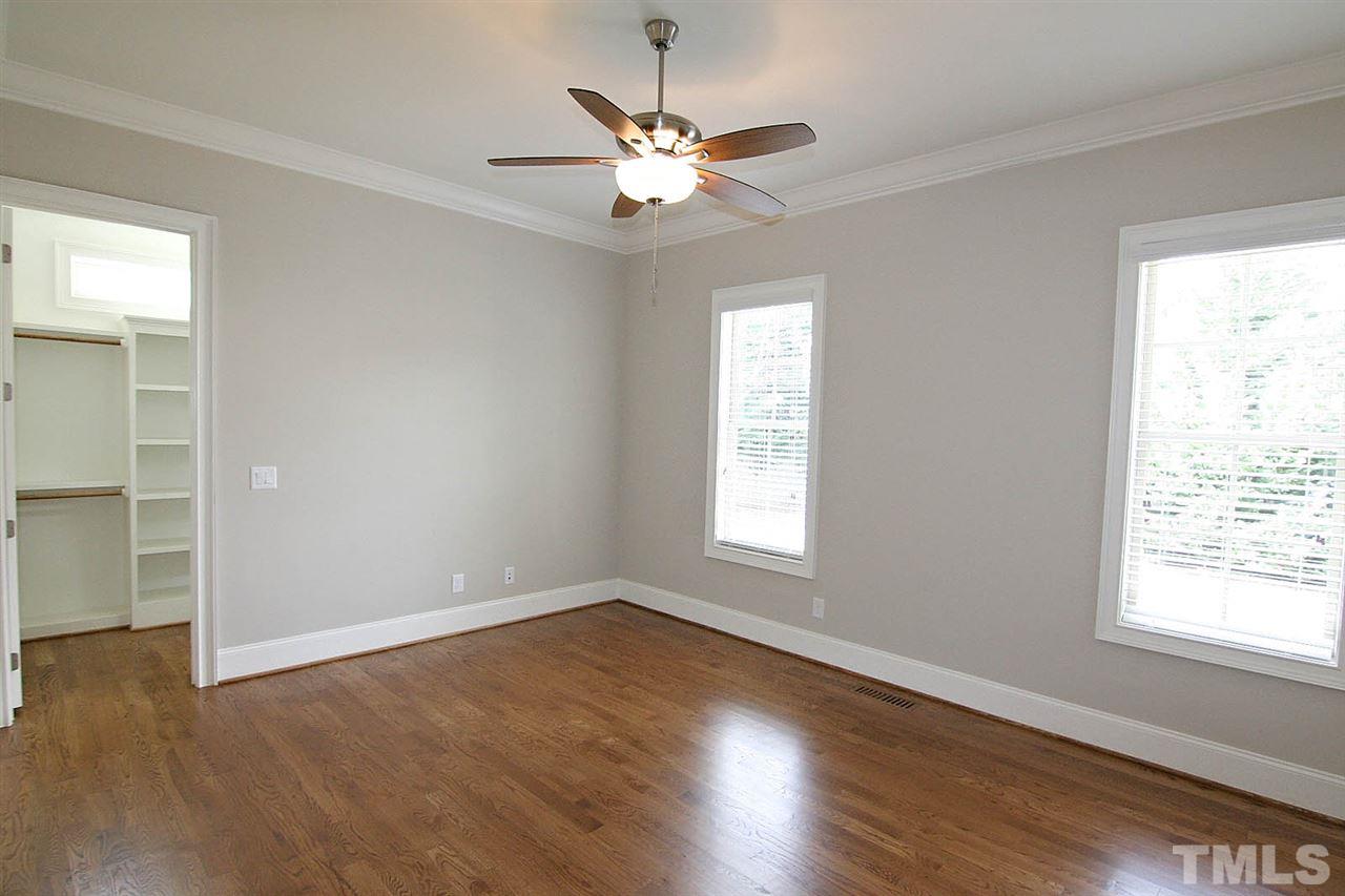 4011 Edwards Mill Road Raleigh, NC 27612 - Photo 16 of 25 a view of an empty room with wooden floor and a window