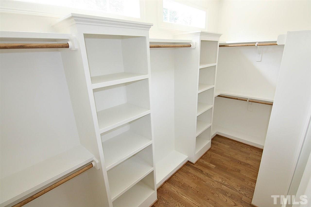 4011 Edwards Mill Road Raleigh, NC 27612 - Photo 18 of 25 a view of walk in closet with empty racks