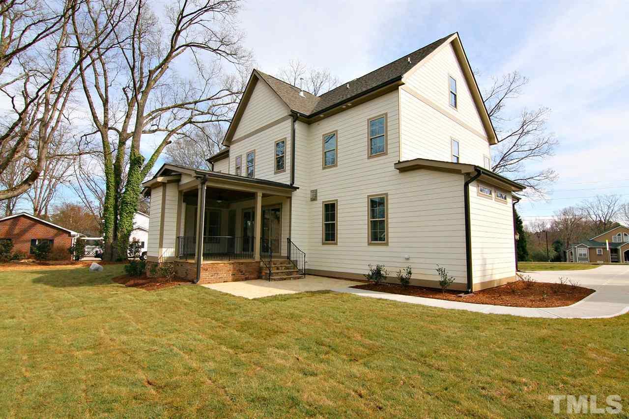4011 Edwards Mill Road Raleigh, NC 27612 - Photo 8 of 25 a view of a white house with a large tree and yard