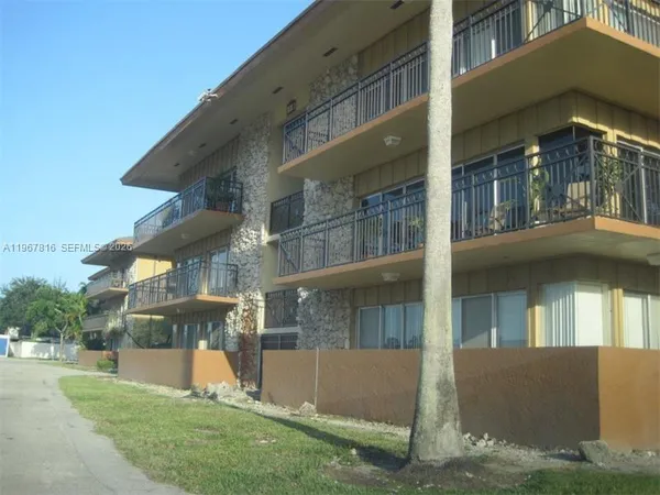 a view of a building with a yard